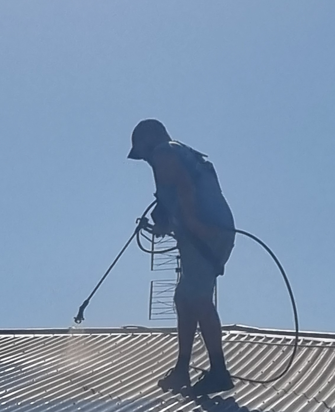 Spray painting a roof surface